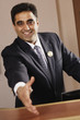 Businessman reaching out to shake the camera's hand