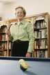 Elderly woman shooting pool