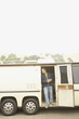 Man standing in doorway to recreational vehicle