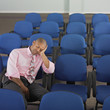 Businessman resting in blue chairs