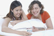 Young women listening to the same mp3 player