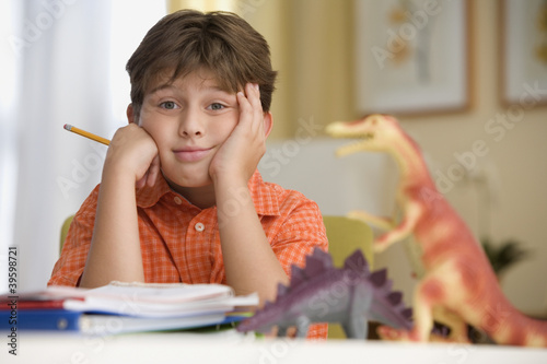 Photo: Young boy sitting at his desk Young boy sitting at his desk
