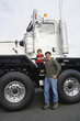 Father standing with his son by their truck