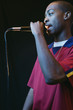 Young man singing into a microphone