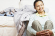 Young woman sitting against the couch