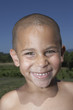 Young boy smiling for the camera with wet hair
