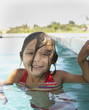 Young girl smiling for the camera in a swimming pool