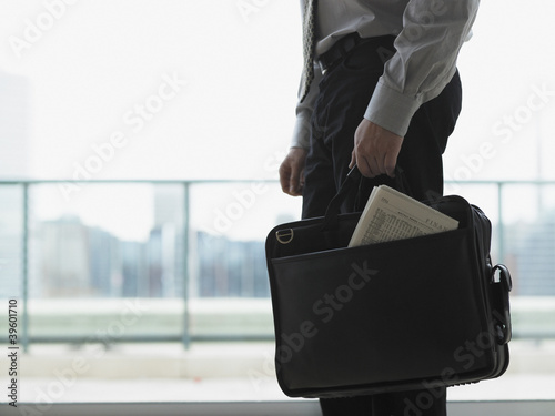 Photo: Young businessman holding his briefcase Young businessman holding his briefcase