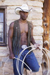 Young man in cowboy outfit posing for the camera