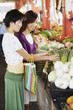 Two women shopping for produce