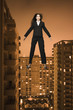 Businesswoman floating above the city