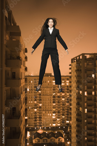 Photo: Businesswoman floating above the city Businesswoman floating above the city