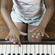 Midsection of girl playing piano