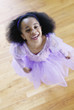 Portrait of a girl in a ballet outfit looking up laughing
