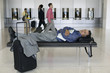 Businessman sleeping at airport