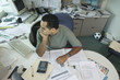 Businessman sitting at messy desk