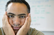 Close up portrait of man with hands on face