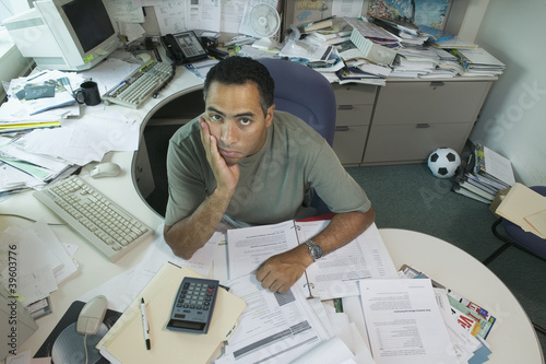 Photo: Portrait of businessman at desk Portrait of businessman at desk