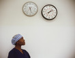 Female surgeon looking at clocks
