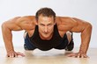 Handsome muscular man doing push-up.