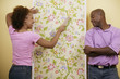 Couple hanging wallpaper
