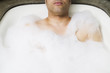 Man soaking in bubble bath