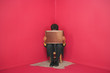 Businessman sitting in chair in corner