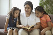 Mother reading to daughters