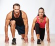 Athletic man and woman doing fitness exercise
