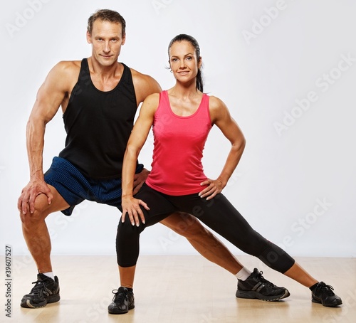 Photo: Athletic man and woman doing fitness exercise Athletic man and woman doing fitness exercise