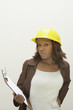 Woman wearing a hard-hat and holding clipboard