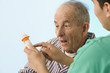 Nurse showing medication to elderly patient