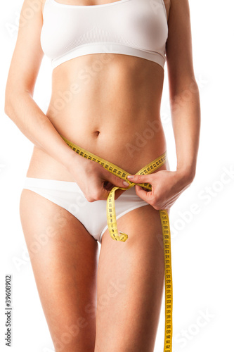 Photo: Woman measuring her body . Woman measuring her body .