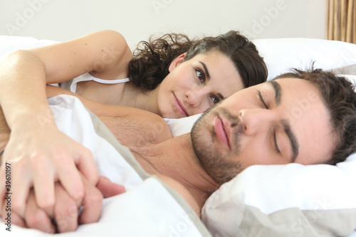 Photo: Woman watching her husband sleeping Woman watching her husband sleeping