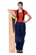 Woman sawing a plank of wood