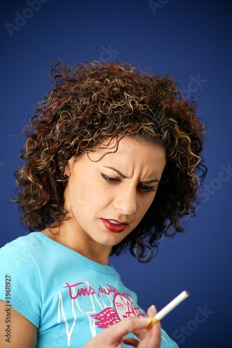 Photo: Frowning woman holding a cigarette Frowning woman holding a cigarette