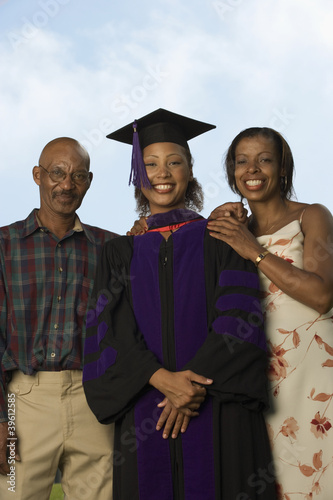 Photo: Female graduate with parents Female graduate with parents