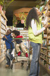 African American mother with young sons in health food store