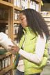 African American woman looking at product in health food store