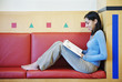 Barefoot teenage girl reading