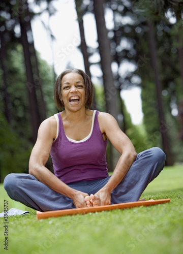 Photo: Senior woman stretching in park Senior woman stretching in park