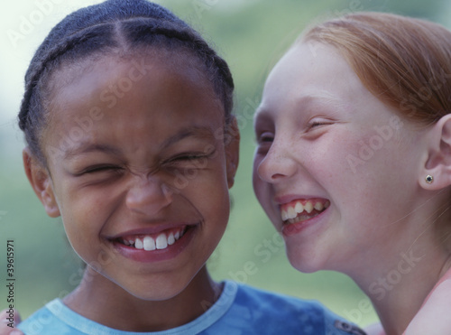 Photo: Close up portrait of two girls giggling Close up portrait of two girls giggling