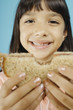 Young girl holding sandwich