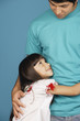 Young girl looking up at young man
