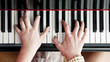 Hands on piano keys