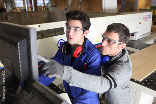 Photo: young apprentice in industry sector with tutor young apprentice in industry sector with tutor