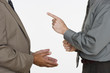 Mid section of two businessmen facing each other with hands gesturing