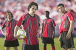 Soccer players posing for the camera on pitch