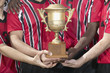 Soccer players holding trophy