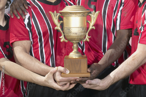 Photo: Soccer players holding trophy Soccer players holding trophy